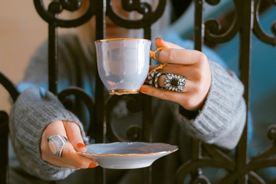 Free Image of Woman Holding Cup and Saucer 
