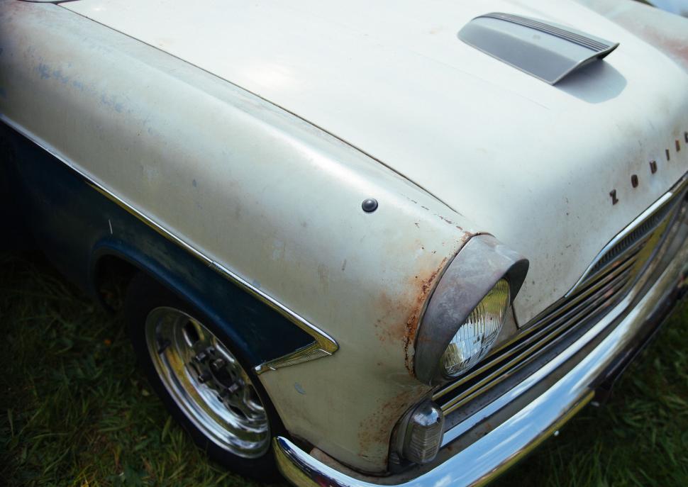 Free Image of Close Up of Vintage Car Parked in Grass 