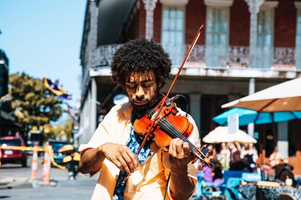 Free Image of Man Playing Violin on City Street 