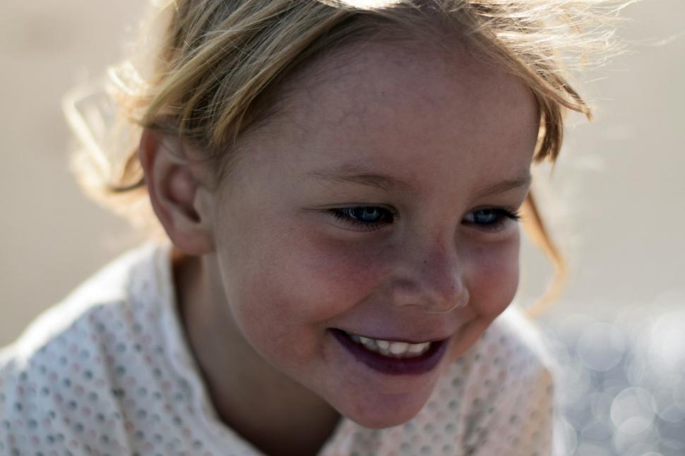 Free Image of Young Girl Smiling and Looking at the Camera 