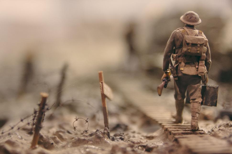 Free Image of Soldier Walking Across Bridge in Field 