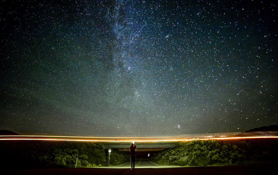 Free Image of Person Standing on Road Under Night Sky 