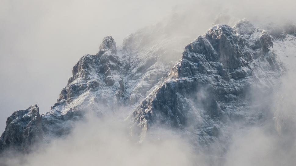 Free Image of Majestic Mountain Peaks Covered in Snow and Clouds 