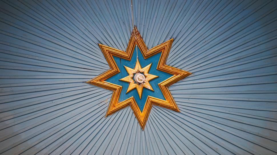 Free Image of Blue and Gold Star Hanging From Ceiling 