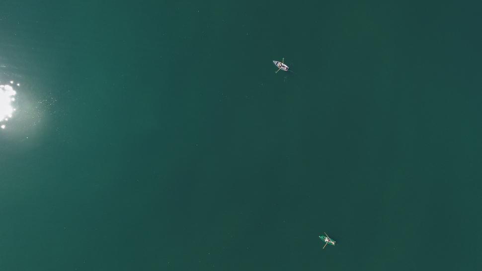 Free Image of Small Boats Floating on a Body of Water 