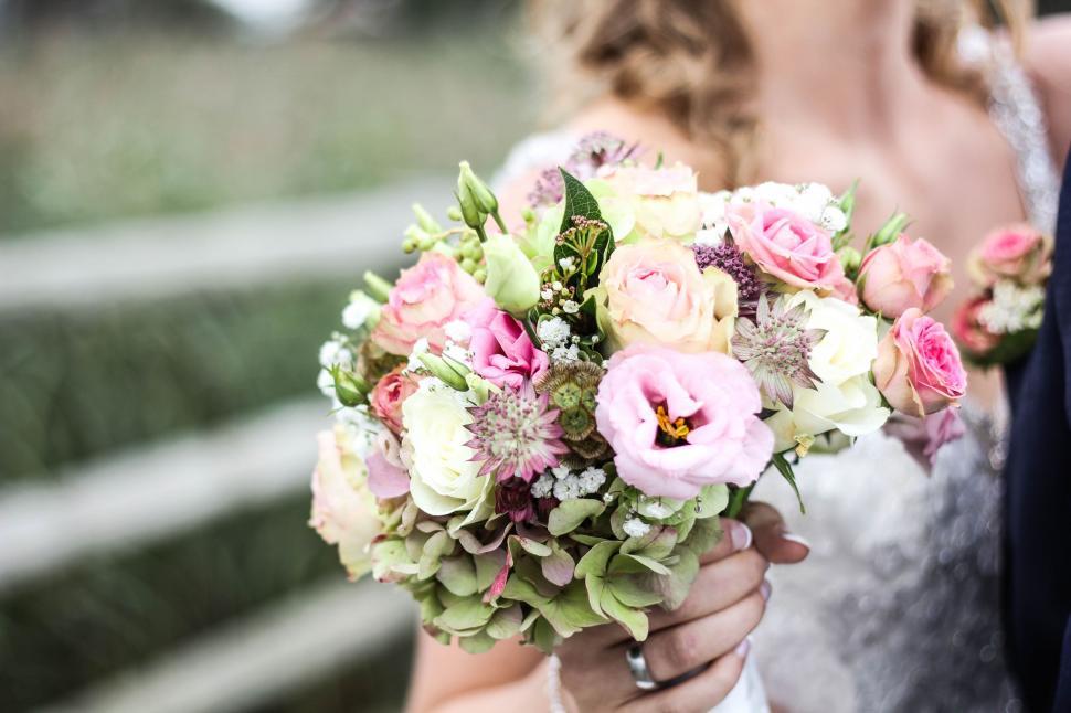 Free Image of Bride and Groom Holding Bouquet of Flowers 