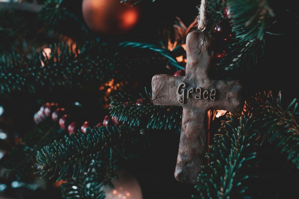 Free Image of Wooden Cross Hanging From a Christmas Tree 