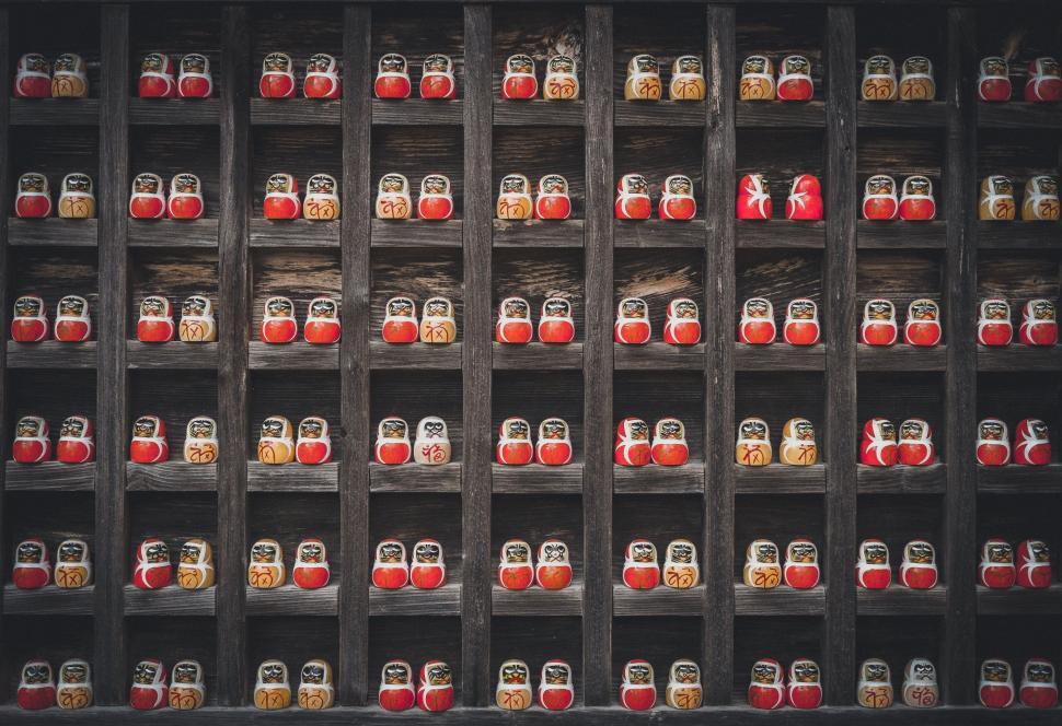 Free Image of Shelf Filled With Red and Yellow Jars 