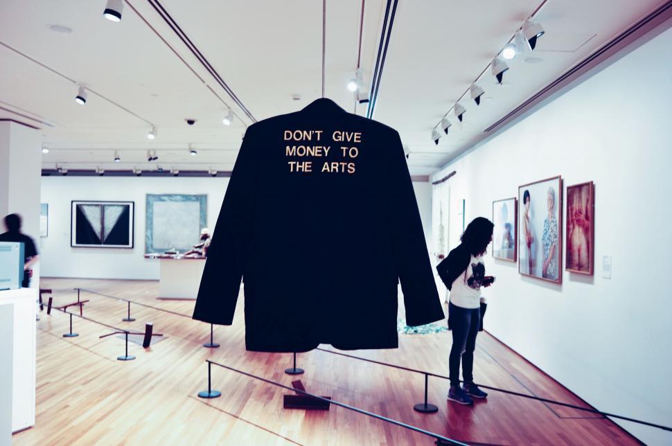 Free Image of Woman Observing Shirt Display at Museum 
