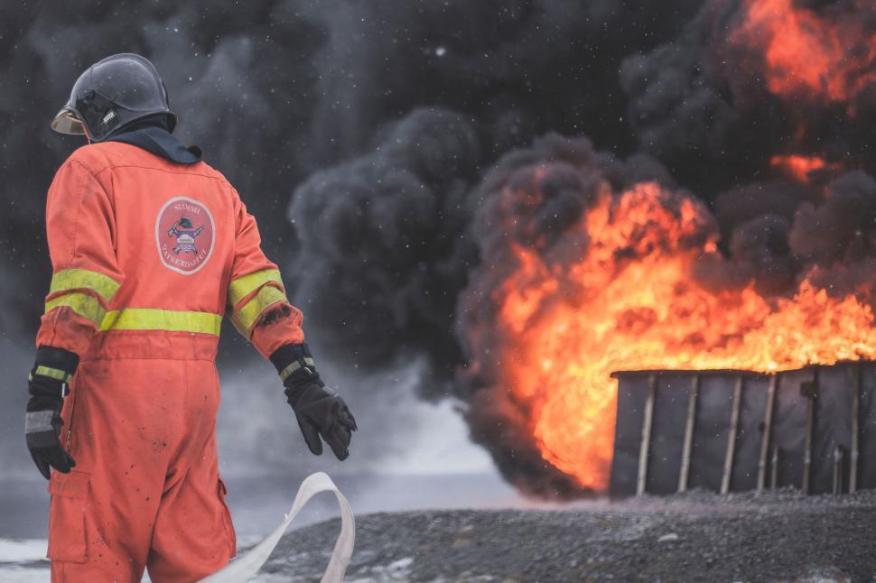 Free Image of Firefighter in Protective Gear Facing a Fire 