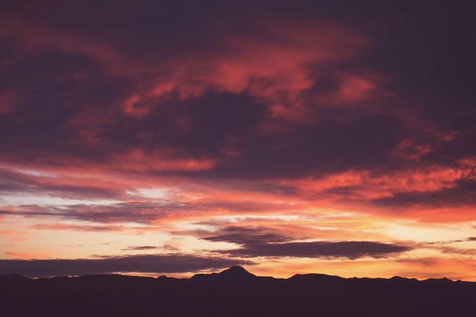 Free Image of Majestic Sunset With Clouds and Mountains 