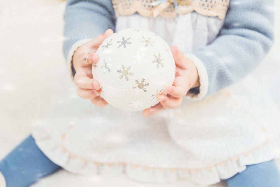 Free Image of Little Girl Holding White Ball 