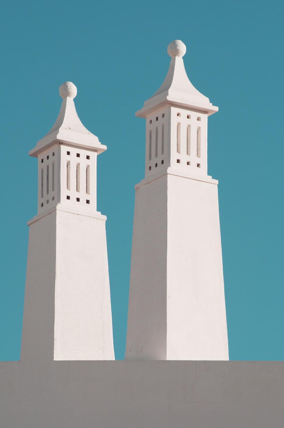 Free Image of Twin White Towers Atop Building 