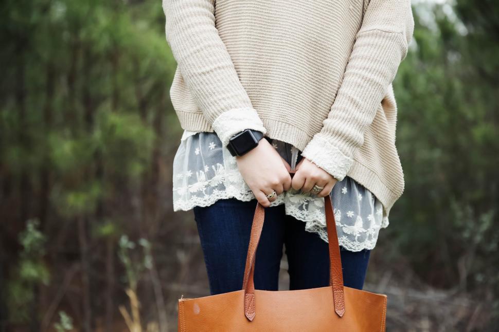 Free Image of Woman Holding a Brown Bag in Her Hands 
