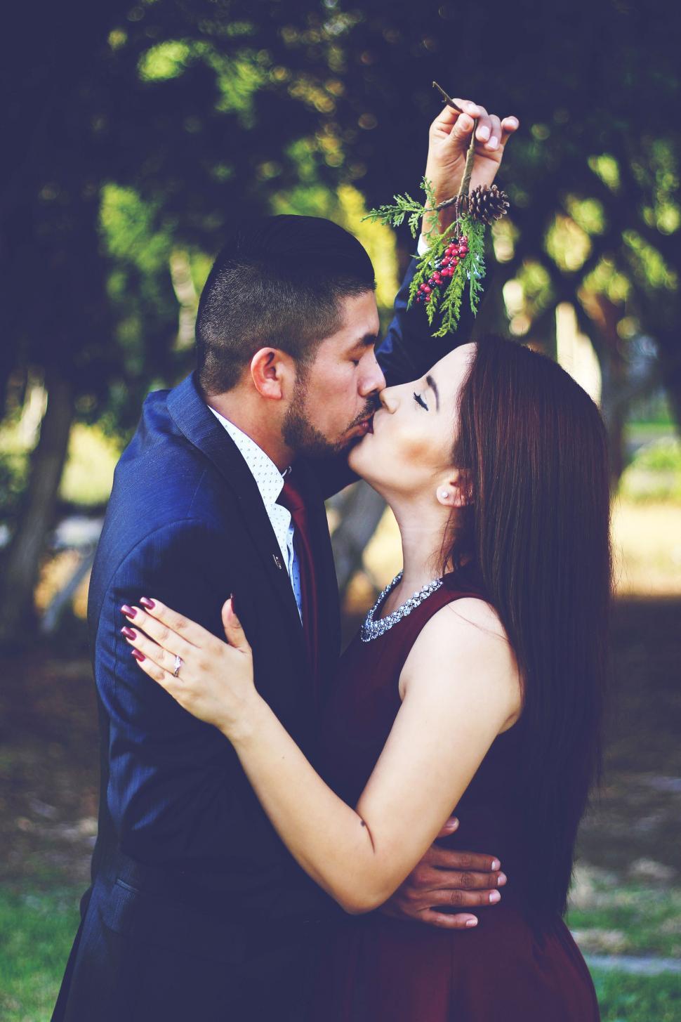 Free Image of Man and Woman Kissing in a Park 