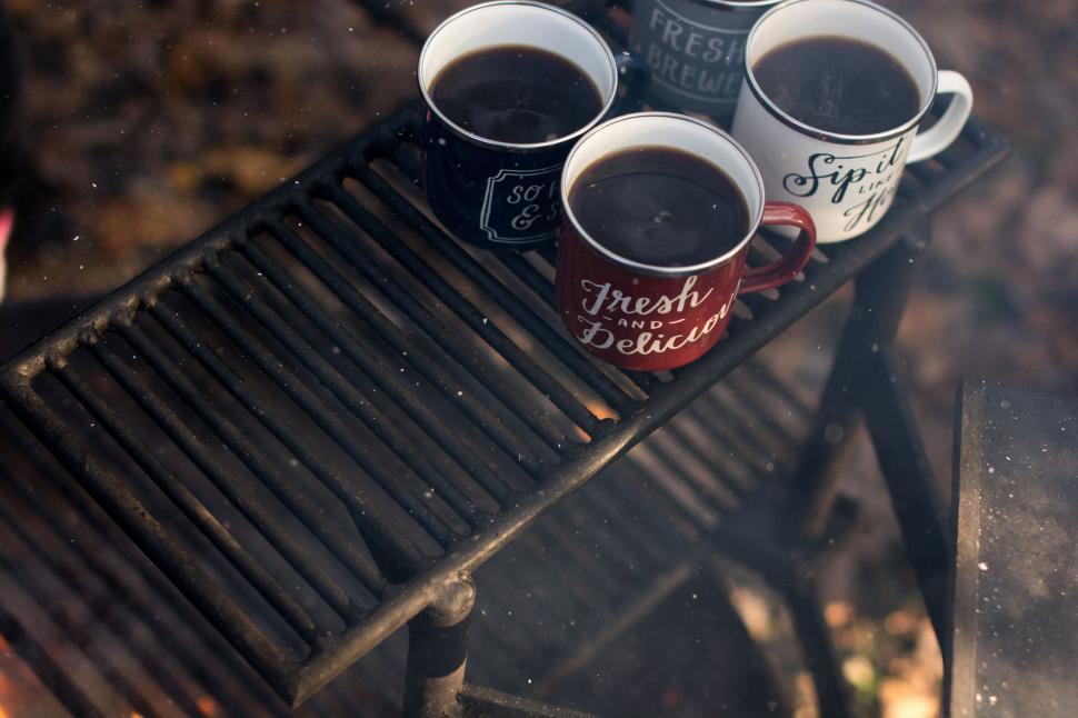 Free Image of Four Cups of Coffee Resting on a Bench 