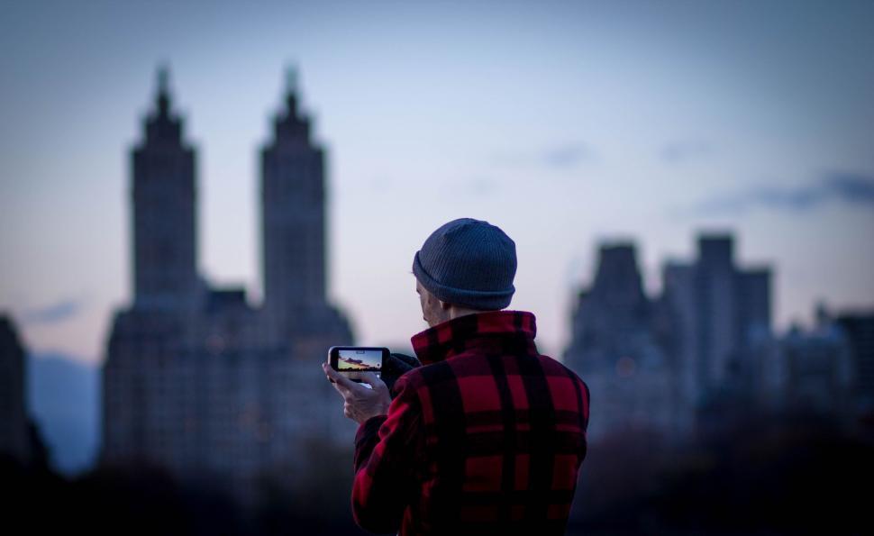 Free Image of Person Taking Picture of City Skyline 