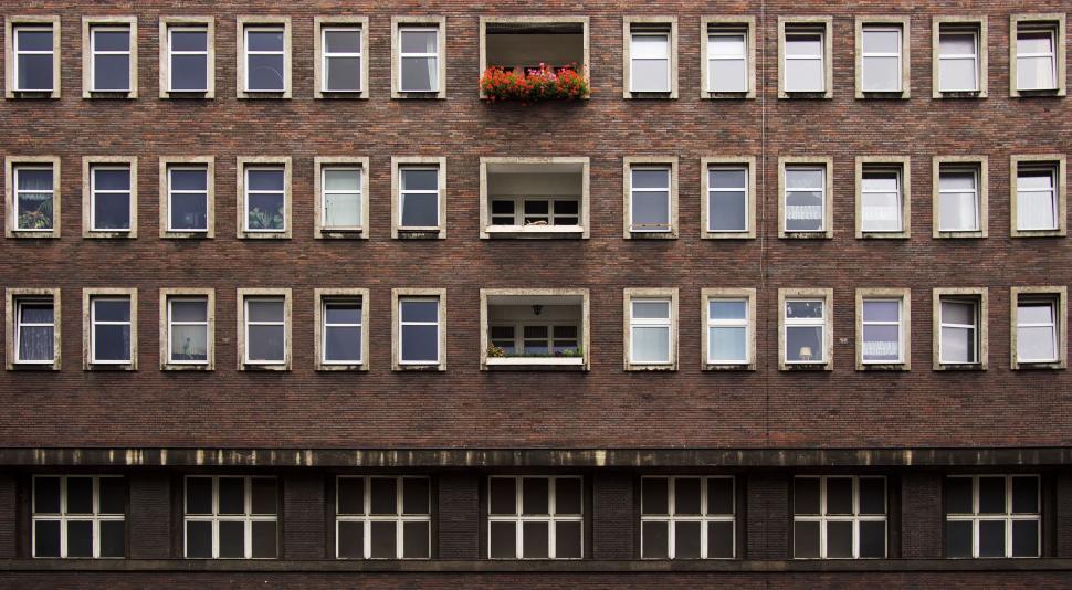 Free Image of Tall Brick Building With Many Windows 