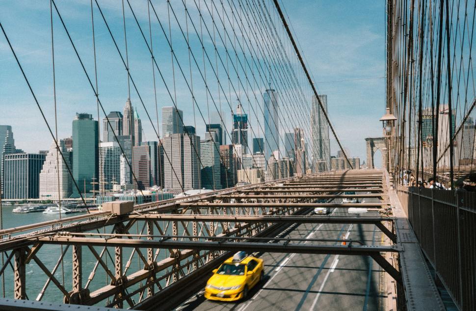 Free Image of Yellow Car Crossing Bridge in New York City 