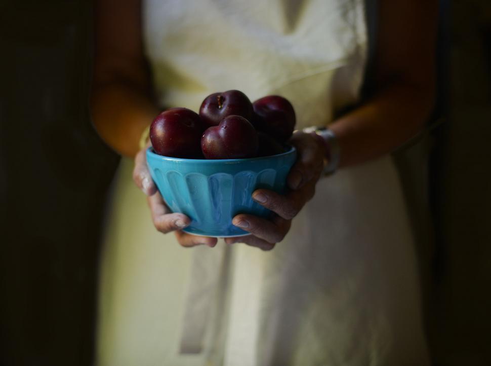 Free Image of Woman Holding a Bowl of Cherries 