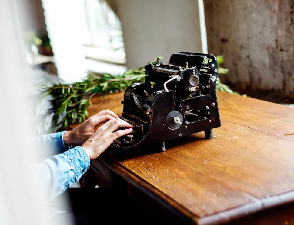 Free Image of Person Typing on Old Fashioned Typewriter 