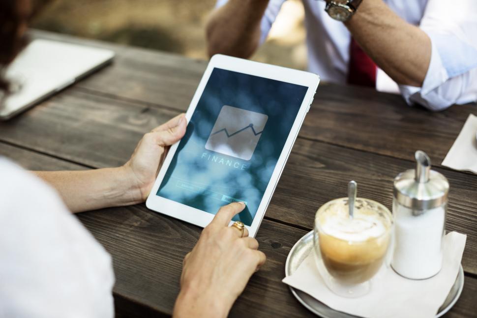Free Image of Person Sitting at Table With Tablet 