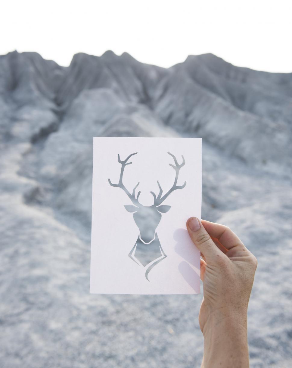 Free Image of Person Holding up Deer Picture 