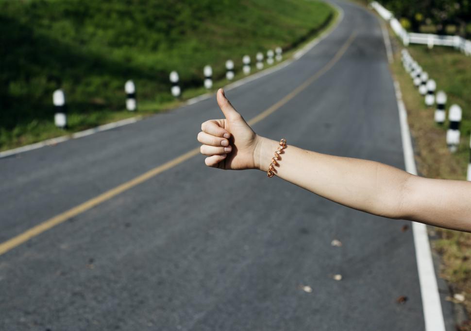 Free Image of Person Giving Thumbs Up on Road 
