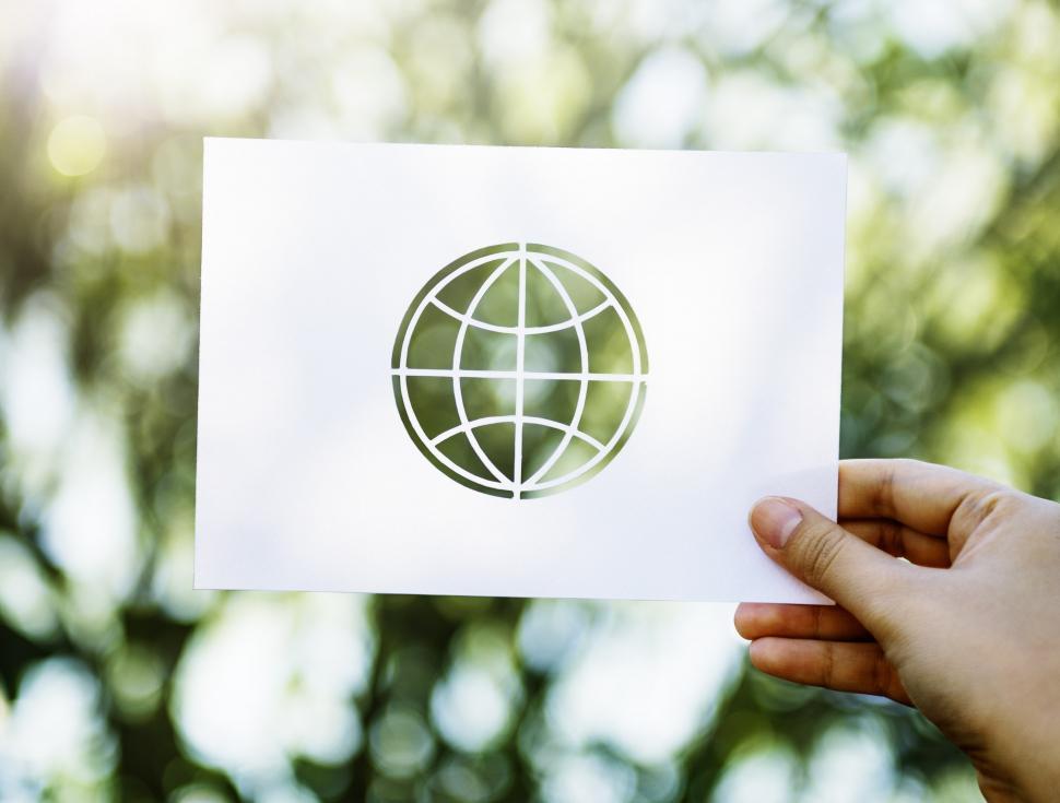 Free Image of Person Holding Up Paper With Globe Picture 