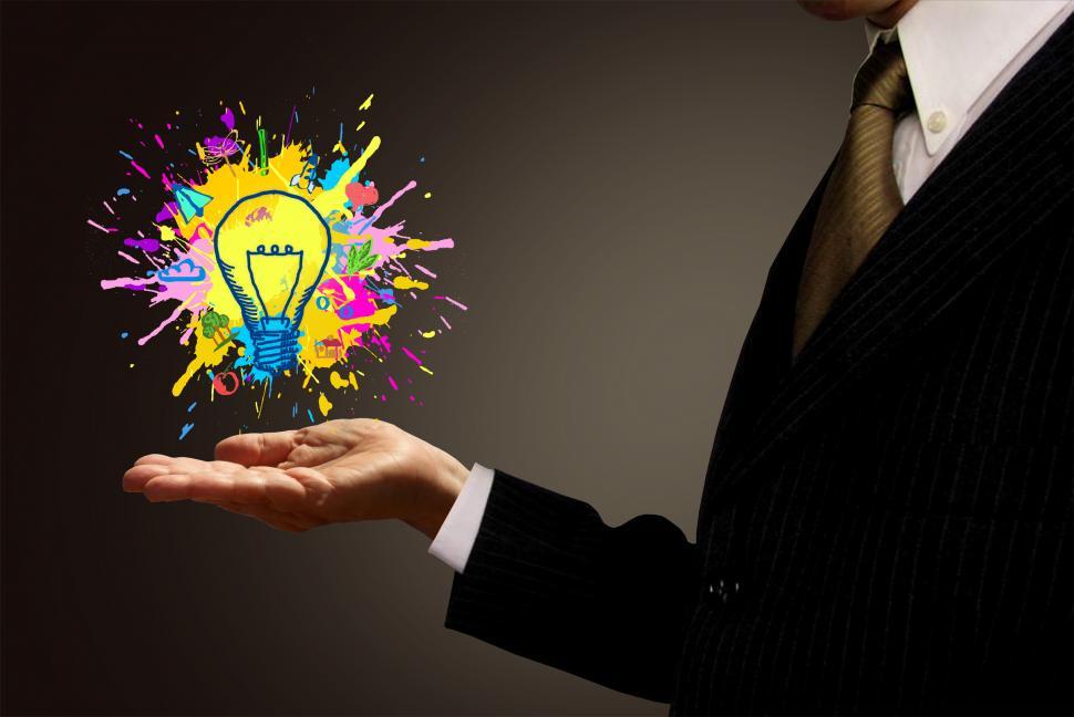 Free Image of Ideas at Hand - Businessman and Painted Lightbulb 