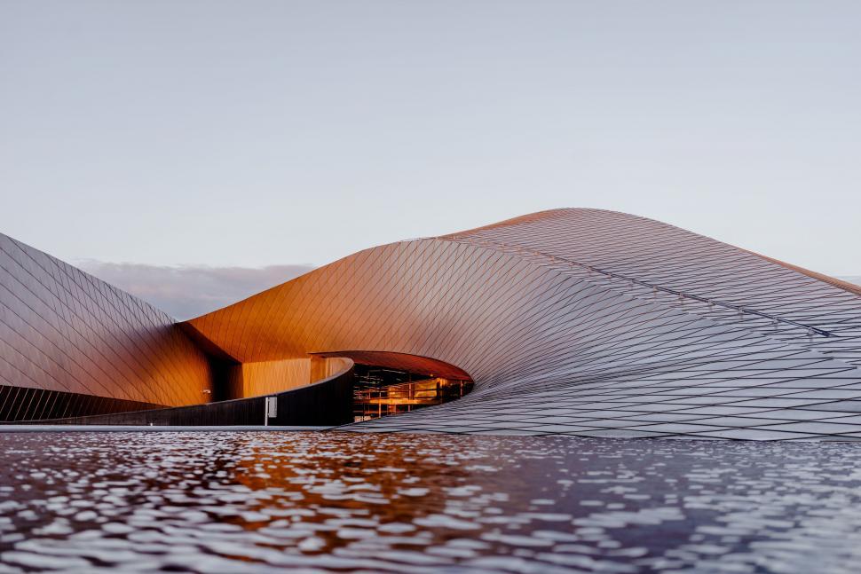 Free Image of Curved Roof Building by Water 