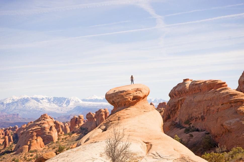 Free Image of Person Standing on Top of Rock Formation 