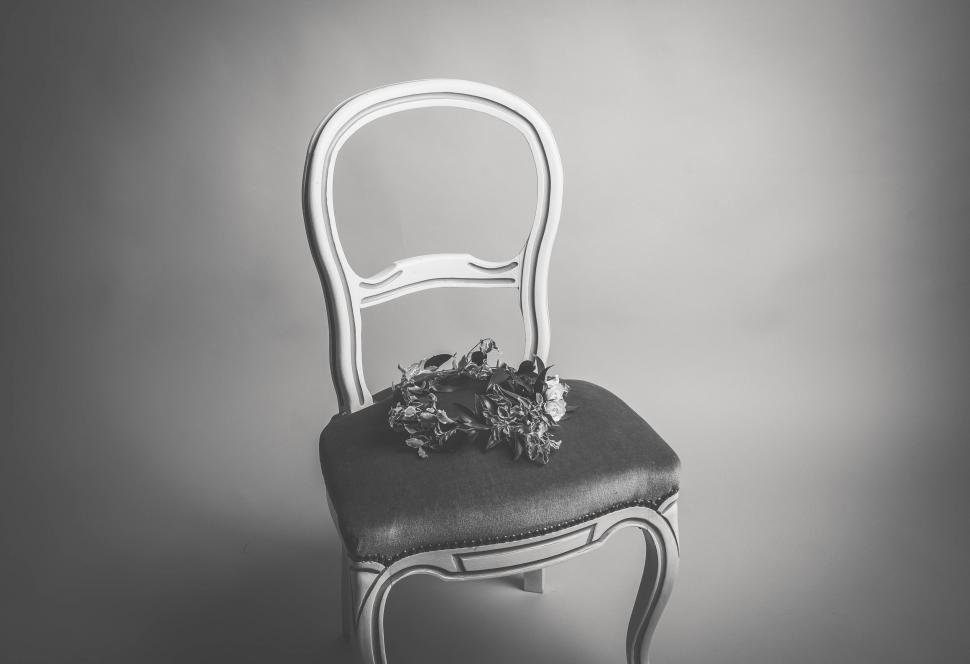 Free Image of Chair With Flowers in Black and White 