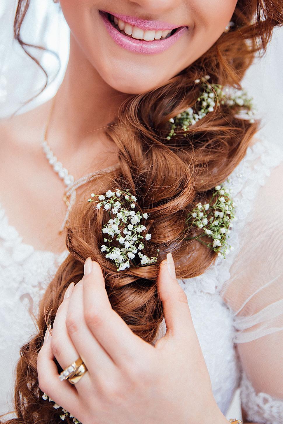Free Image of Woman Wearing Wedding Dress With Flowers in Hair 