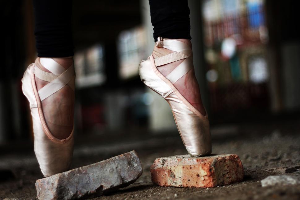 Free Image of Person Wearing Ballet Shoes Standing on Brick 