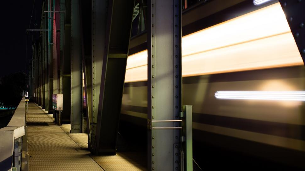 Free Image of Train Traveling Past a Train Station at Night 