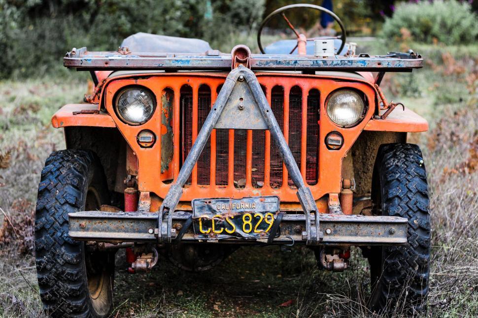 Free Image of Orange Jeep Parked in Field 