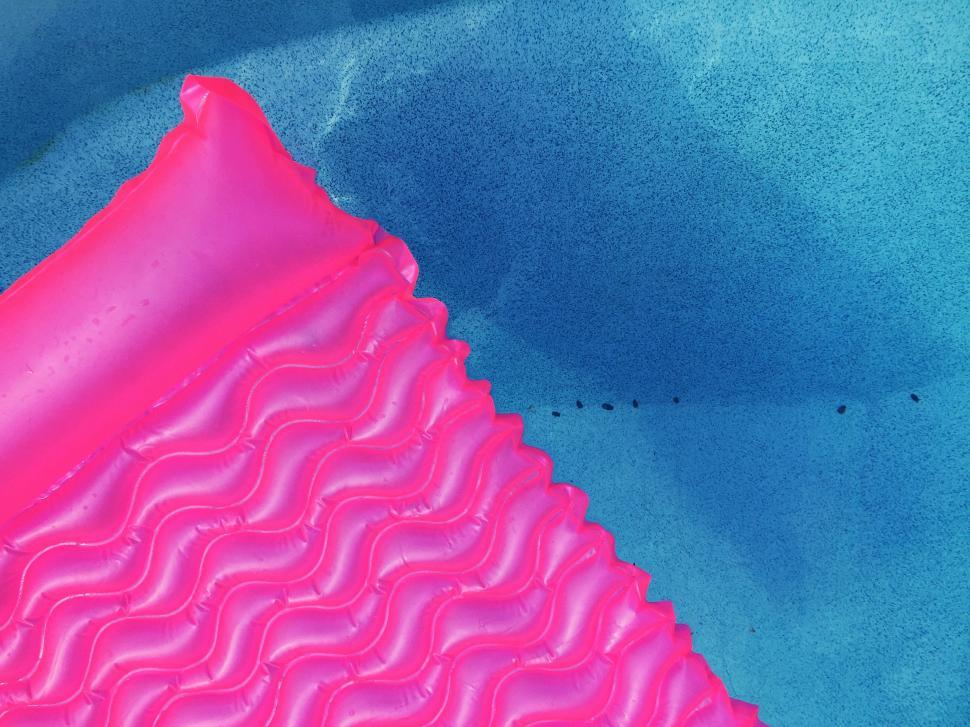 Free Image of Close Up of Pink Object on Blue Surface 