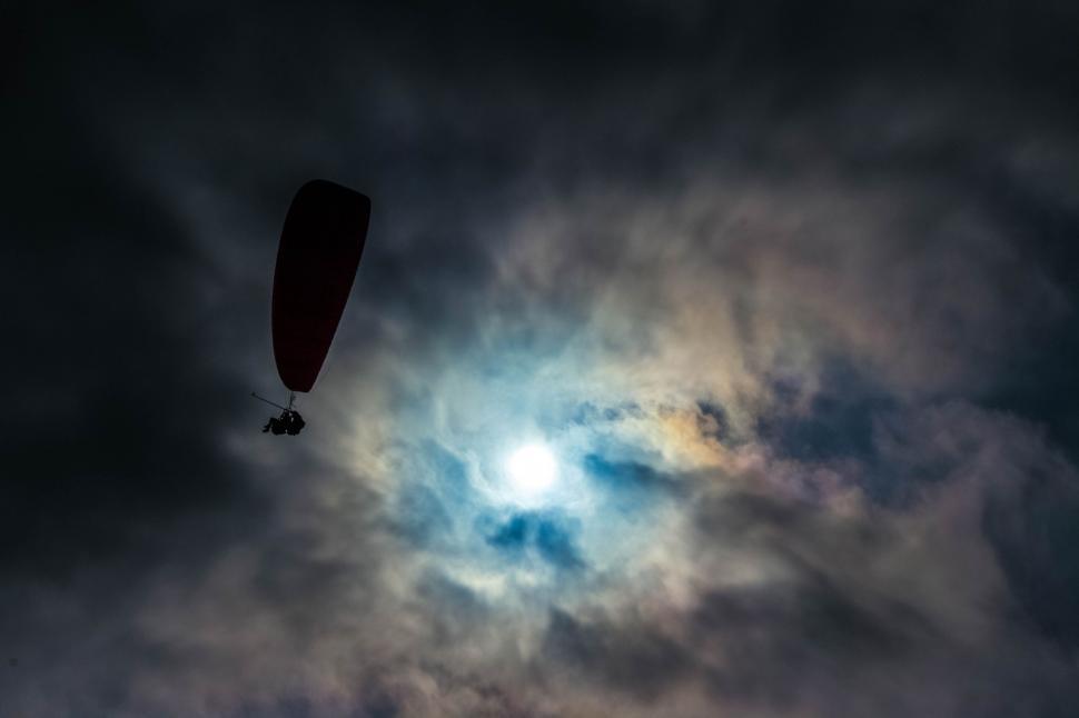 Free Image of Hot Air Balloon Flying Through Cloudy Sky 