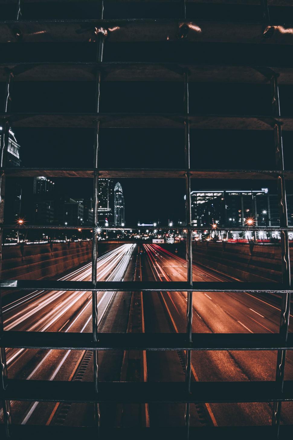 Free Image of City Street View Through Fence 