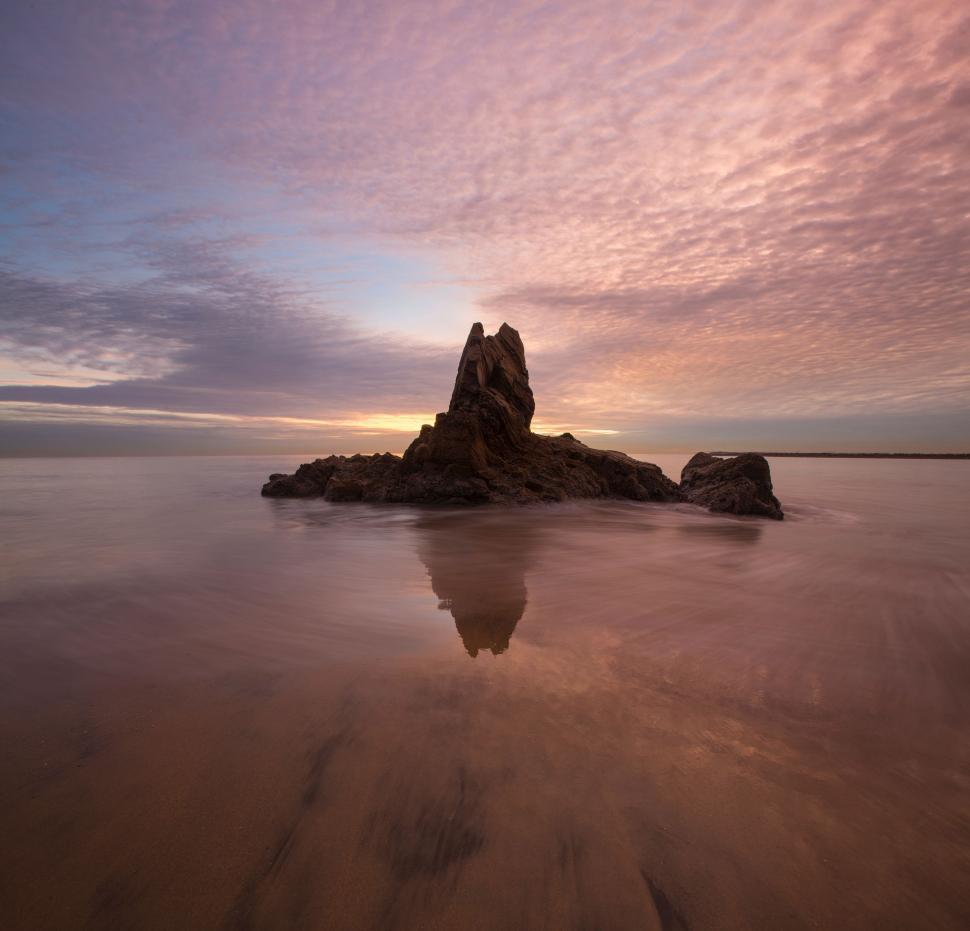 Free Image of Large Rock on Sandy Beach 