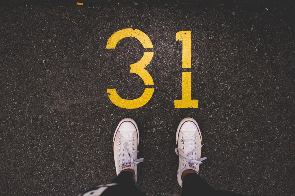 Free Image of Person Standing in Front of Number Thirteen 
