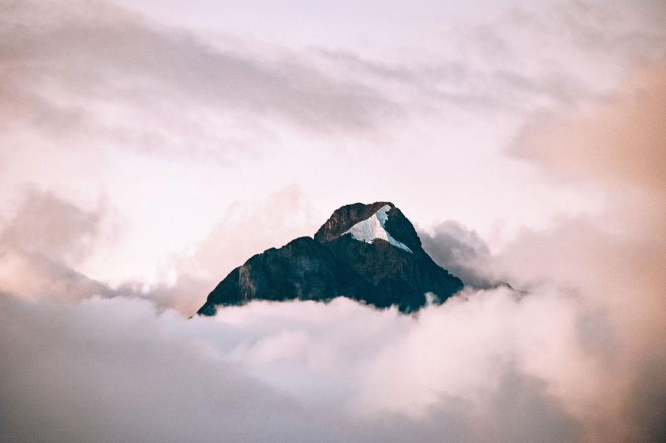 Free Image of Mountain Rising Above Cloud-Filled Sky 