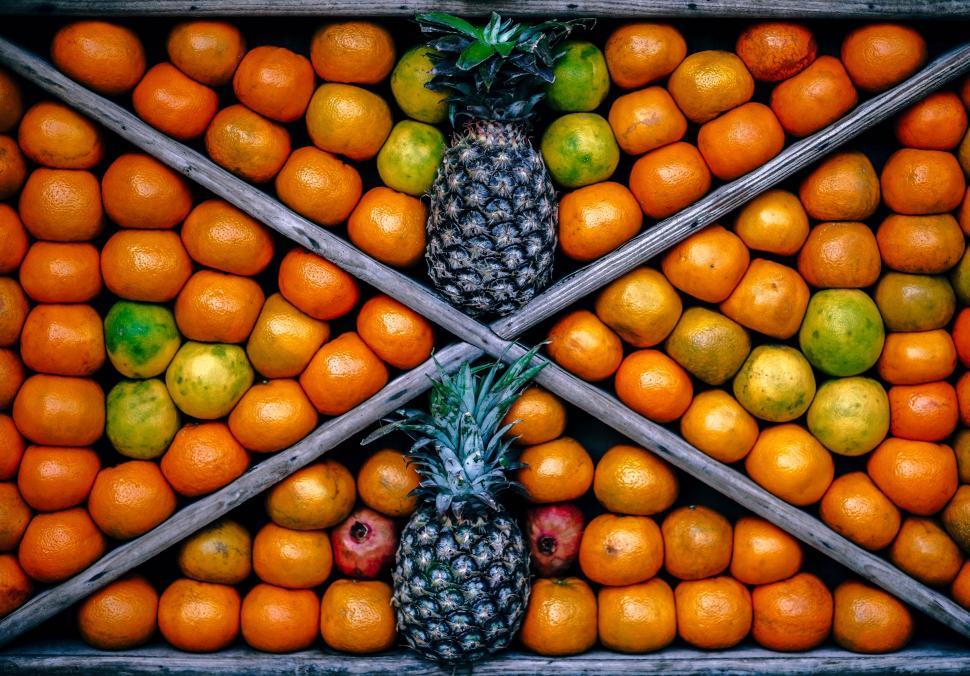 Free Image of Arrangement of Pineapples, Oranges, and Other Fruit in a Pattern 