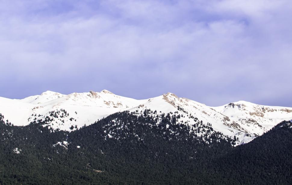 Free Image of Snow Covered Mountain Range Under Cloudy Blue Sky 