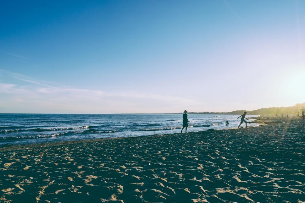 Free Image of Couple Standing on Sandy Beach 