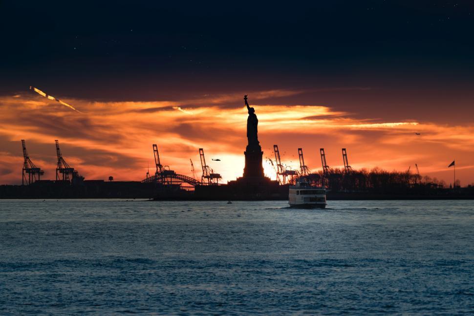 Free Image of Statue of Liberty Silhouetted Against Sunset 