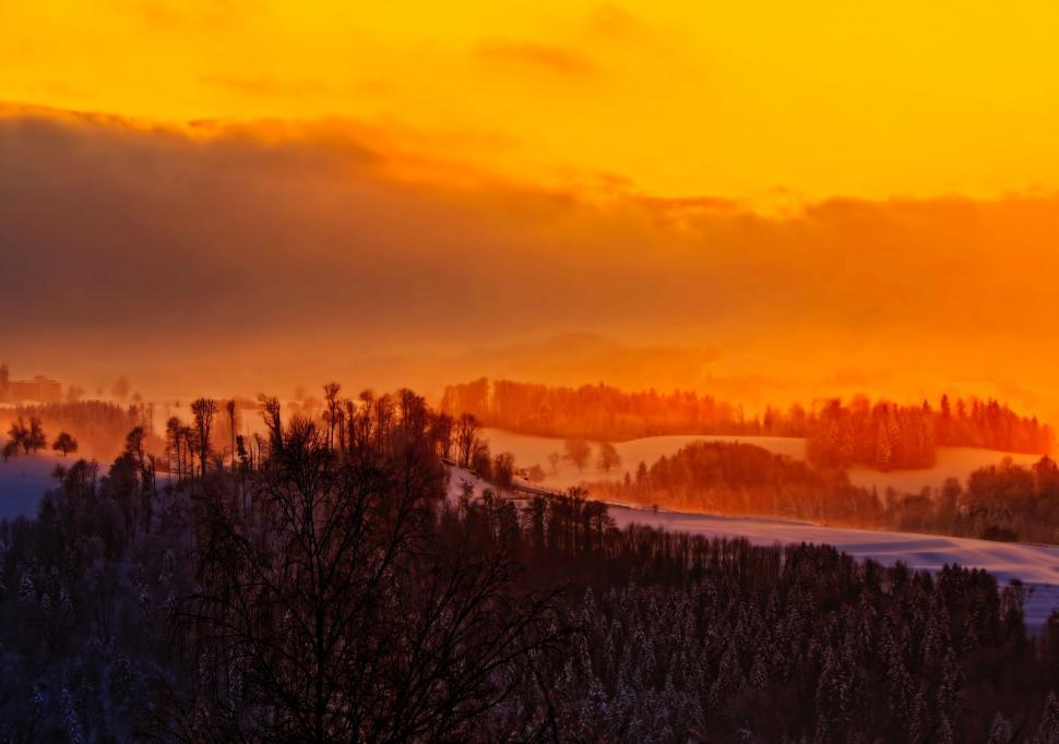 Free Image of Sun Setting Over Snowy Landscape 