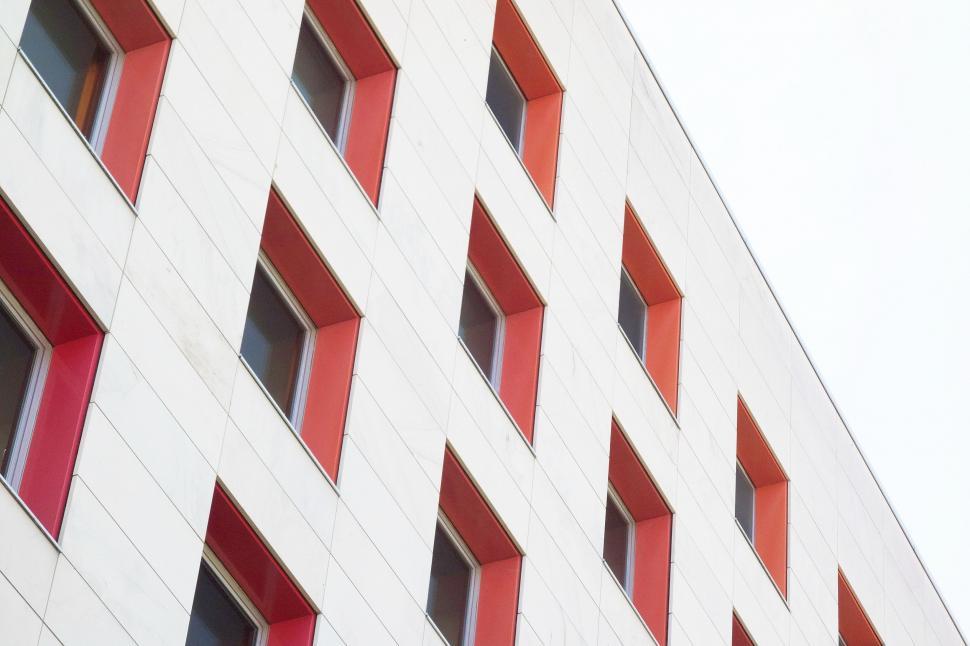Free Image of Red and White Building With Red Windows 