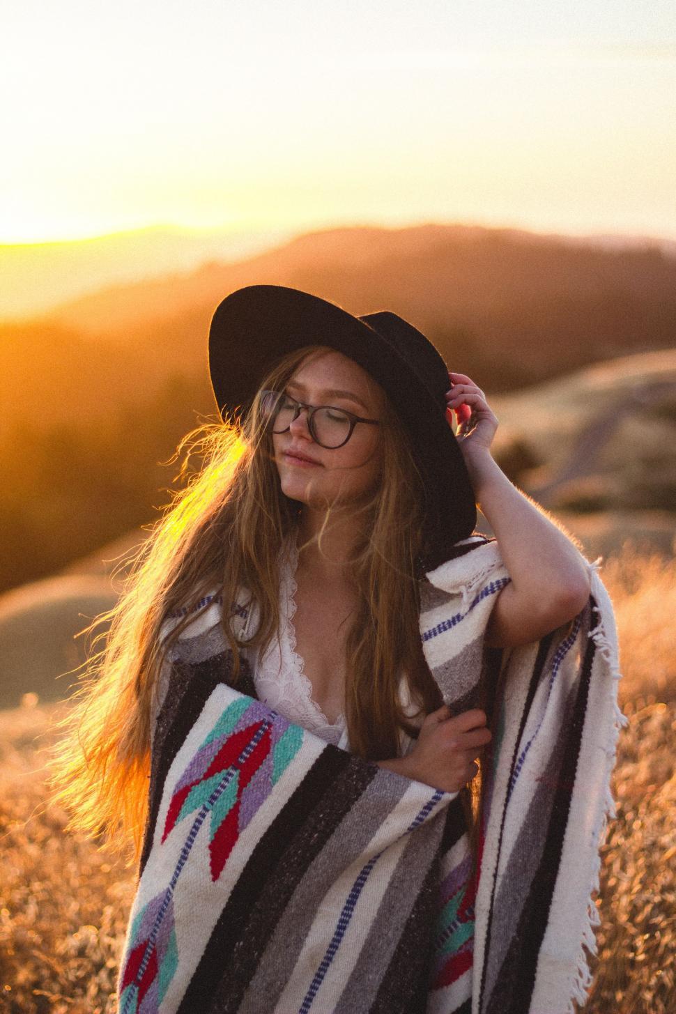 Free Image of Woman Wearing Hat and Blanket in Field 